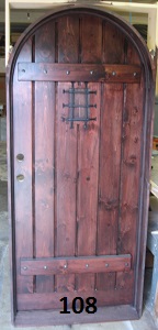 Wood door with arch top and iron grill