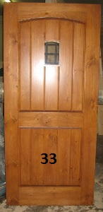 Exterior door with arched panel and small window
