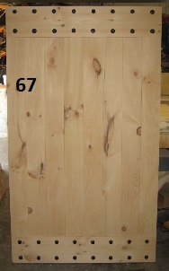 Exterior stockade door with iron clavos and custom braces
