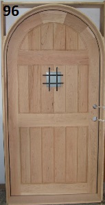 Ash frame and panel arch top door with iron grillr