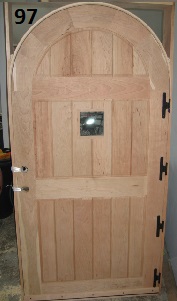 Exterior arch top frame and panel door with small window